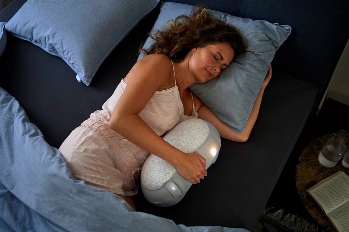 Person sleeping with wearable sleep tracking technology